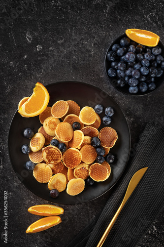 Wallpaper Mural Top view over trendy mini pancakes on black background Torontodigital.ca