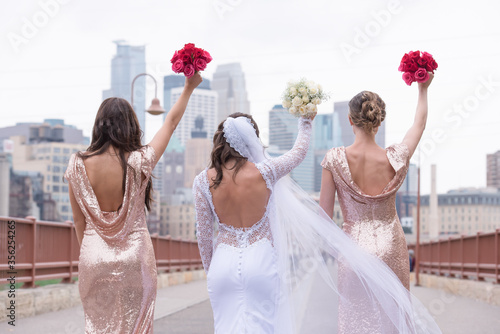 Bride with girlfriends on Stone Arch Bridge Minneapolis
