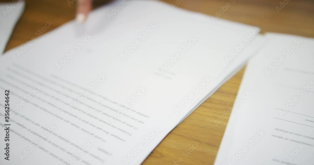 CU SELECTIVE FOCUS Business people discussing documents during meeting / Covent Garden, London, England, United Kingdom CU SELECTIVE FOCUS Business people discussing documents during meeting / Covent Garden, London, England, United Kingdom