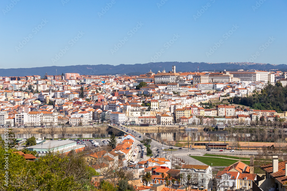 historic Coimbra cityscape with university at top of the hill in the evening, Portugal