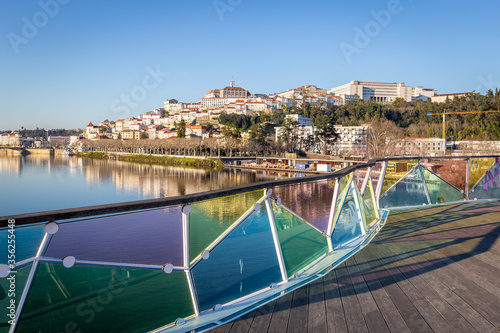 historic Coimbra cityscape with university at top of the hill in the evening, Portugal