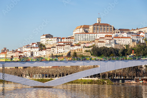 historic Coimbra cityscape with university at top of the hill in the evening, Portugal