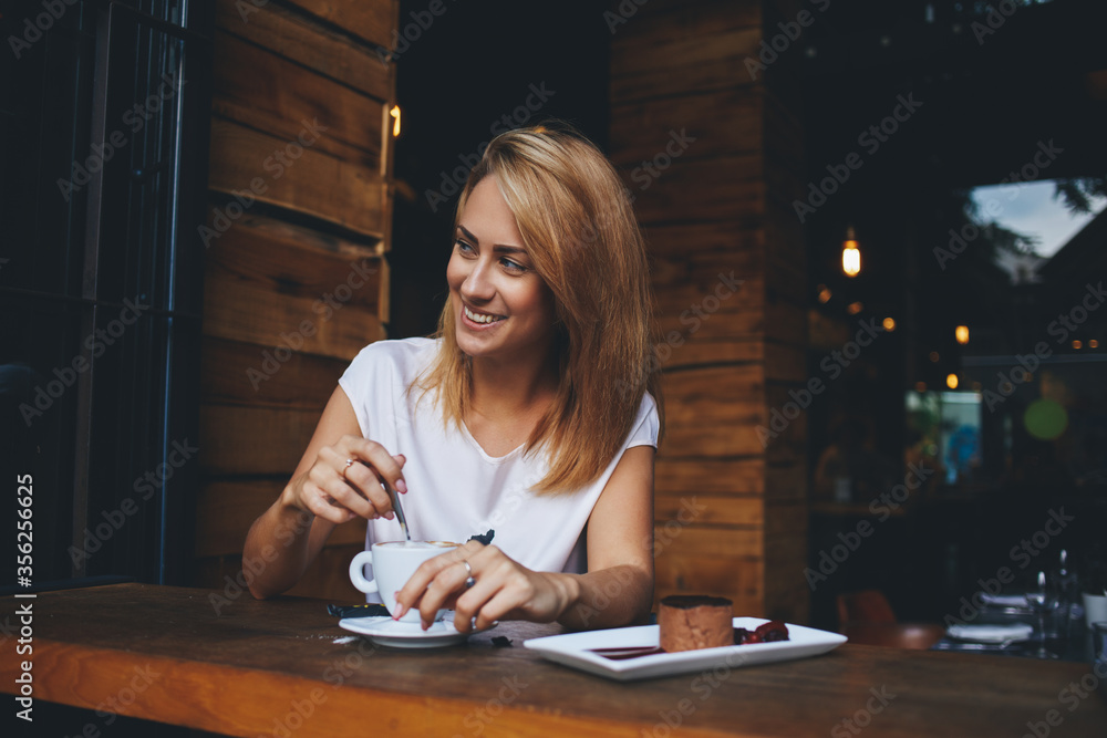 happy hipster girl making photo with cell telephone for a chat with friends while sitting in cafe happy hipster girl making photo with cell telephone for a chat with friends while sitting in cafe