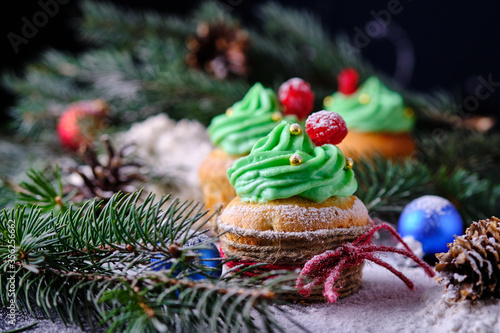 Christmas cupcakes in a festive and snowy forest. Dessert for New Year and Christmas celebration.