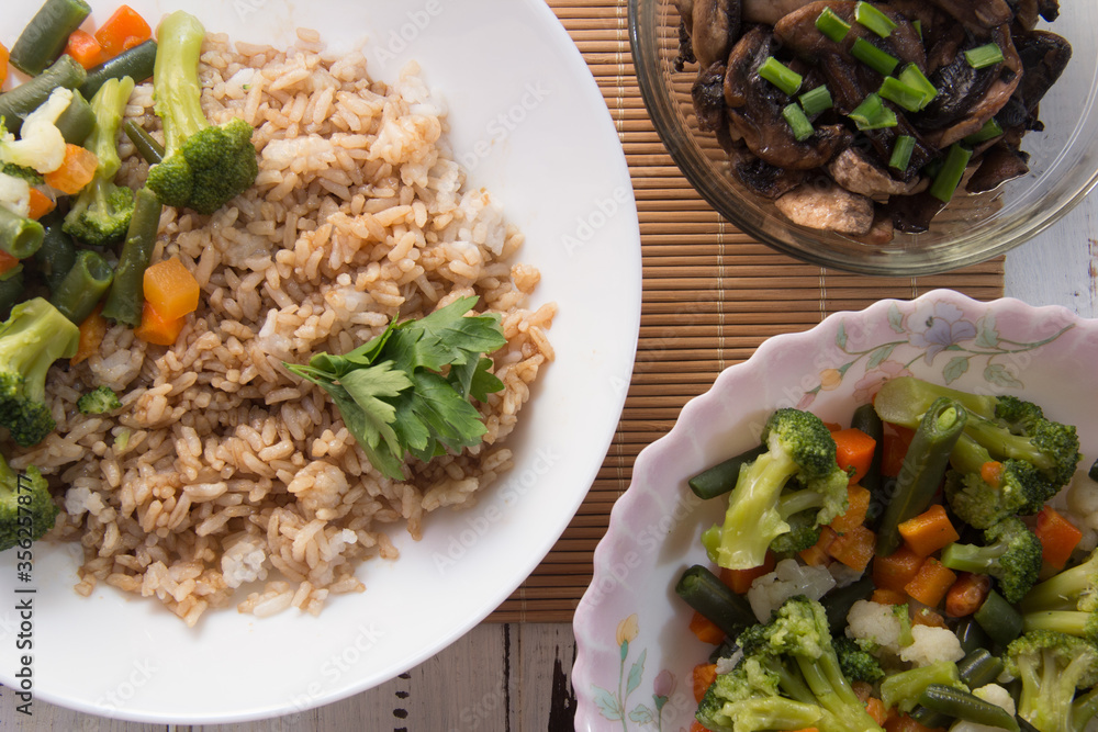 Rice with soy sauce and boiled vegetables close-up on a decorative background. Rice Dish. Fried mushrooms. Healthy eating Vegetarian food. Vegetarian dish