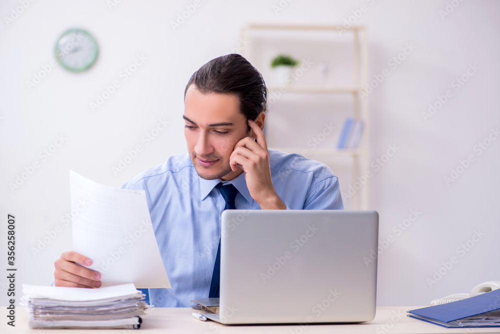 Young male employee in the office Young male employee in the office