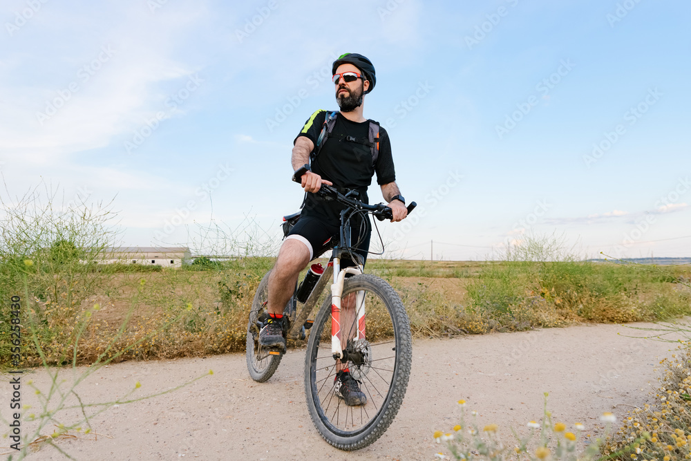 
cyclist waiting for his companions
