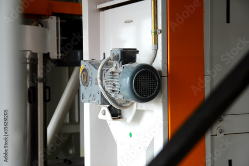 Industrial electric motor and pipes. grain mill