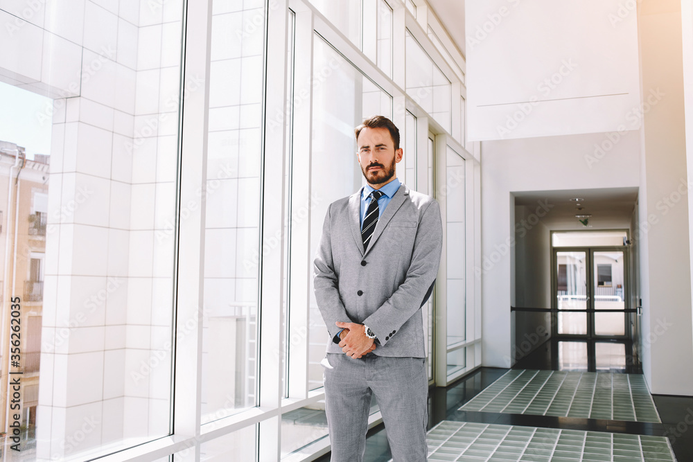 Happy businessman glad to signing contract with new clients, while is standing in hallway company Happy businessman glad to signing contract with new clients, while is standing in hallway company