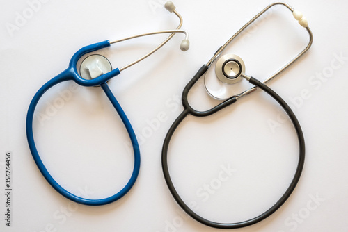 two stethoscopes in rounded shape one blue and one black