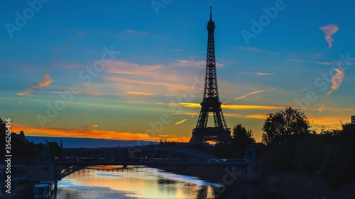 Architecture of Paris with Eiffel Tower, Seine river and Pont Rouelle at dawn photo