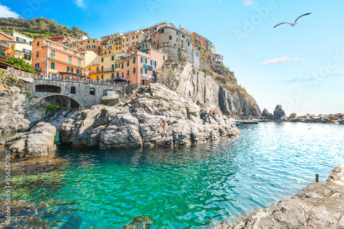 The turquoise bay and swimming area at the village of Manarola, one of the five villaged of the Cinque Terre, a World Heritage Site.