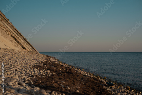 Fototapeta Naklejka Na Ścianę i Meble -  A rocky beach next to a body of water