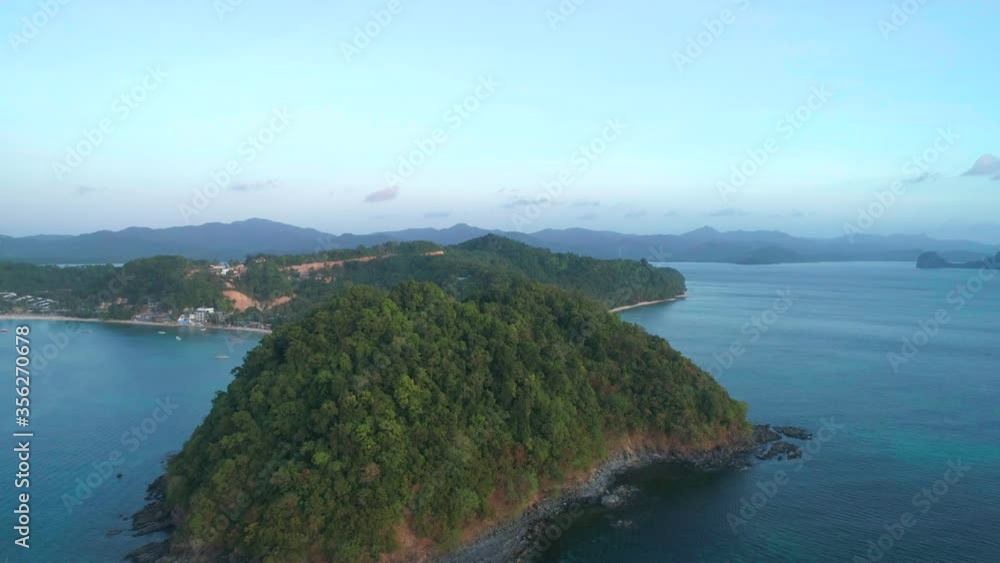 Aerial view from above on a tropical island at sunset. Aerial view from above on a tropical island at sunset.