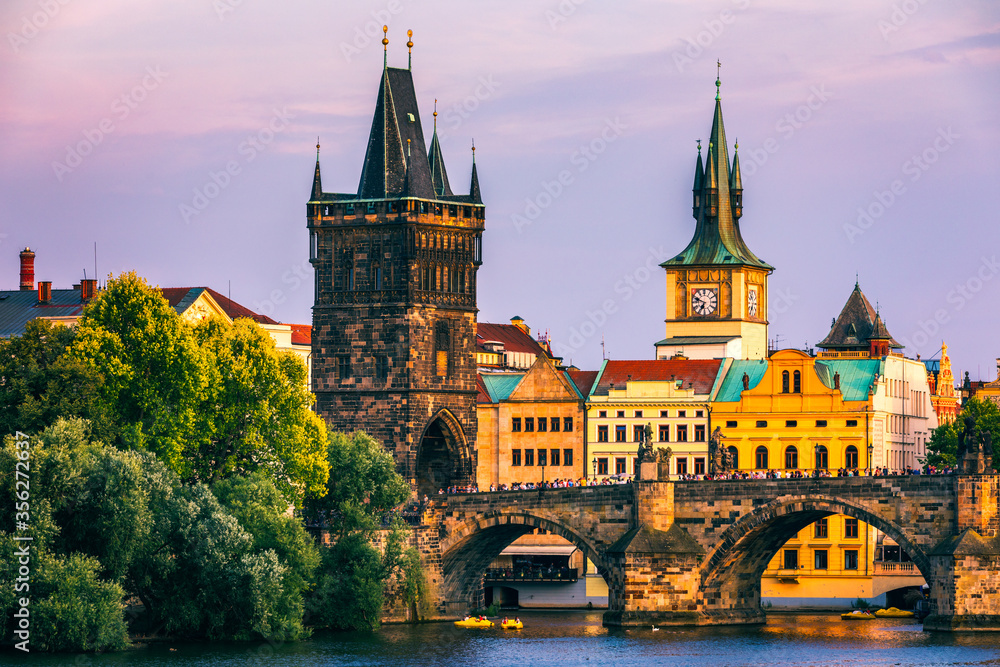 Charles Bridge in Prague in Czechia. Prague, Czech Republic. Charles Bridge (Karluv Most) and Old Town Tower. Vltava River and Charles Bridge. Concept of world travel, sightseeing and tourism.