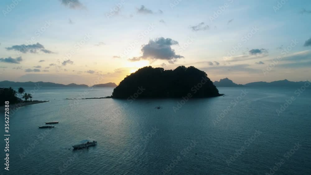 Aerial view from above on a tropical island at sunset. Aerial view from above on a tropical island at sunset.