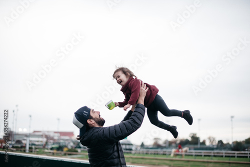 Father holding daughter up in the air