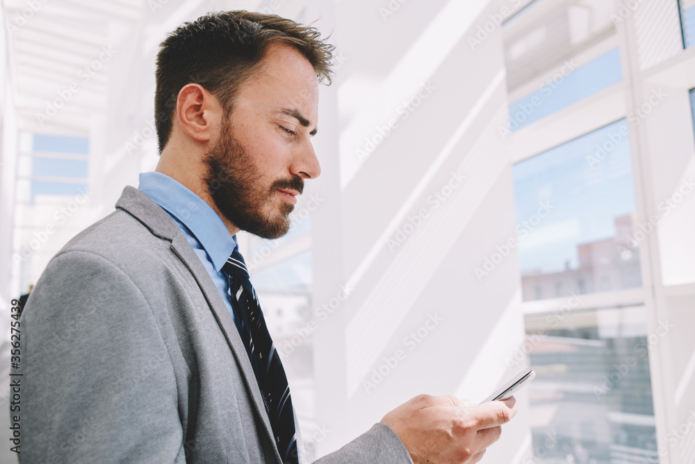 Fototapeta premium Intelligent male lawyer working on touch pad during work break