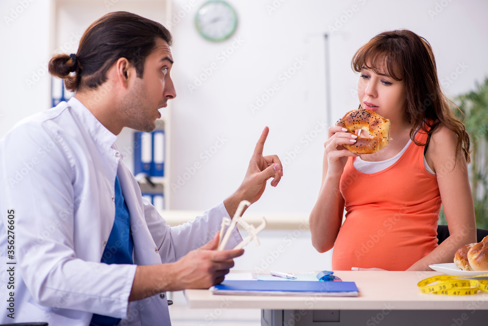 Pregnant woman visiting male doctor gynecologist Pregnant woman visiting male doctor gynecologist