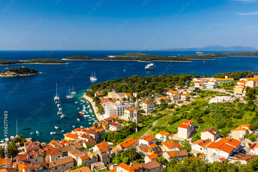 Obraz premium View at amazing archipelago in front of town Hvar, Croatia. Harbor of old Adriatic island town Hvar. Popular touristic destination of Croatia. Amazing Hvar city on Hvar island, Croatia.