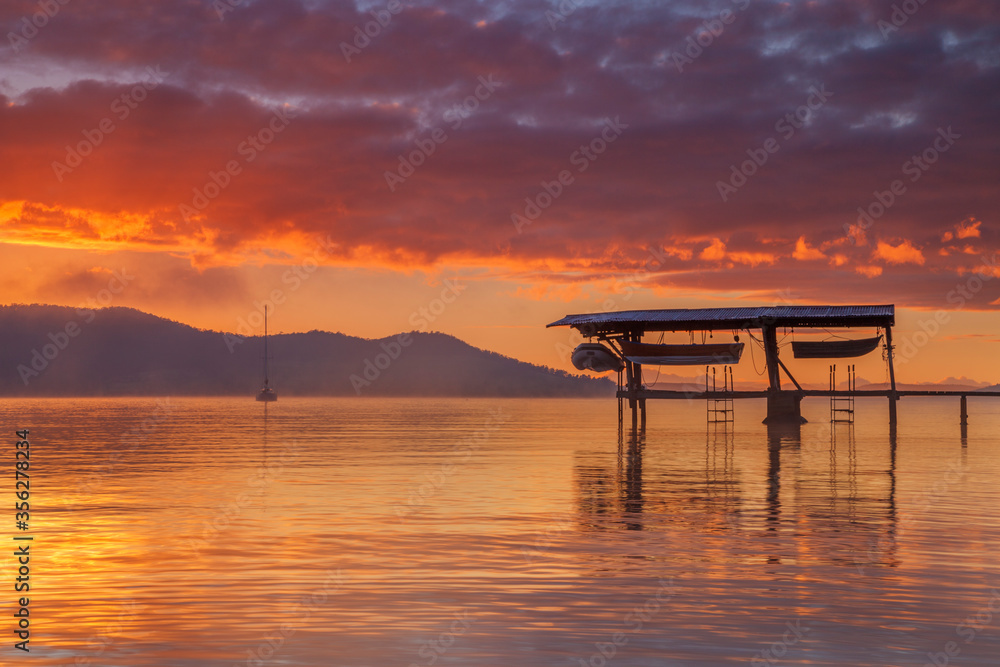 Beautiful winter's sunrise over Coningham Boat Shed.North West Bay.South East Coast of Tasmania,Australia.