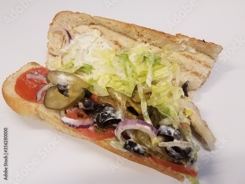 chicken sandwhich with olives, pickles, tomato and lettuce