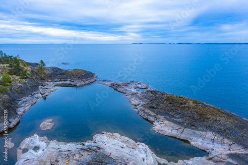 Panorama of Karelia from a height. The Russian landscape. Northern nature. View of lake Ladoga from the shore. Rocky coast of Ladoga. Karelian skerries. Travel to Russia.