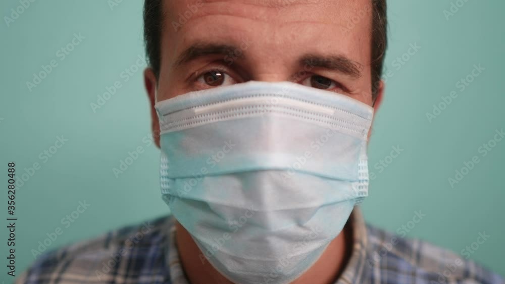 man wear protective mask a indoor portrait. epidemic corona outbreak concept. male 37 years old brunette in medical mask isolated. Coronavirus disease. dad lifestyle teamwork self-isolation in home man wear protective mask a indoor portrait. epidemic corona outbreak concept. male 37 years old brunette in medical mask isolated. Coronavirus disease. dad lifestyle teamwork self-isolation in home
