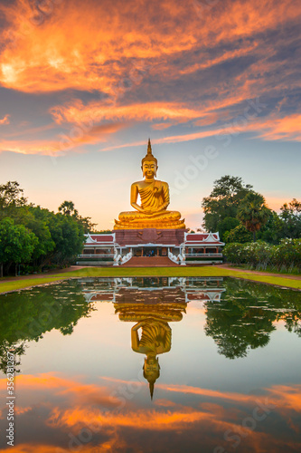 Bild auf Leinwand Beautiful Big Golden Buddha statue sunset sky in Thailand temple,khueang nai District, Ubon Ratchathani province, Thailand