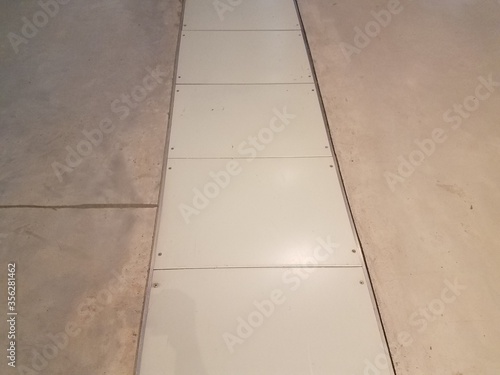 cement floor with white access panels