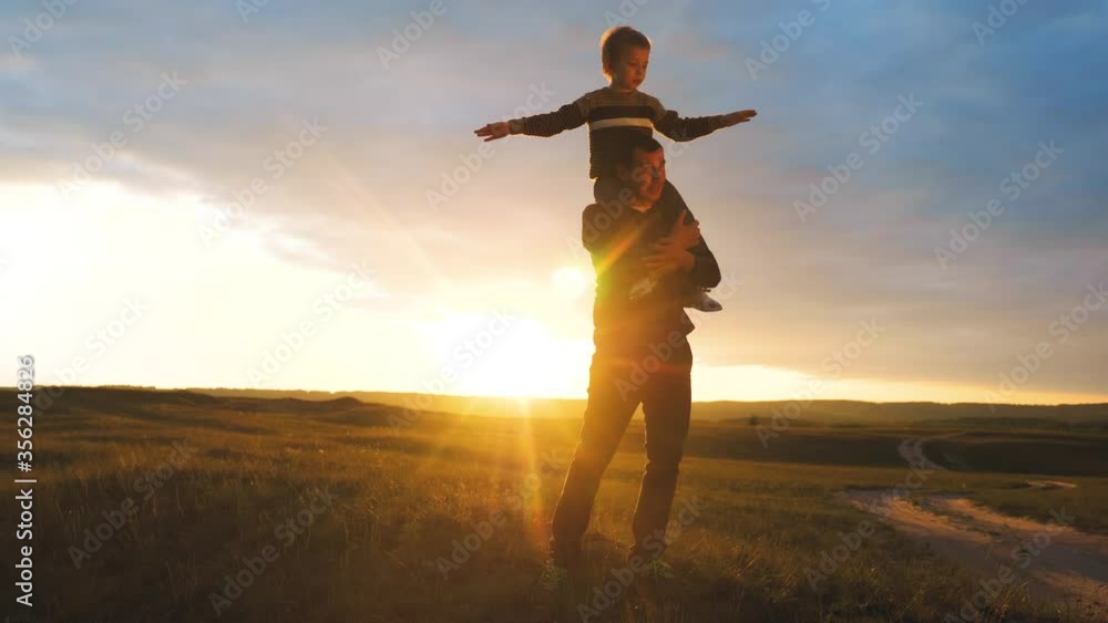 custom made wallpaper toronto digitalhappy family. son sits on his neck teamwork at father shows hands to the side plays at the pilot depicts an airplane silhouette at sunset. happy family concept childhood man dad with little lifestyle