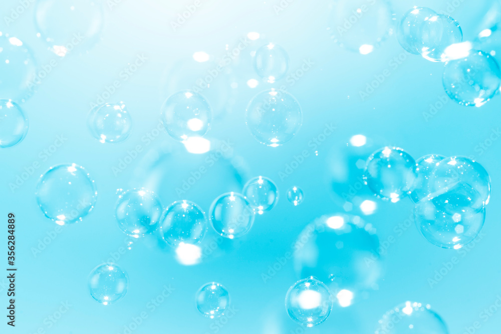 Beautiful blue soap bubbles float as background.