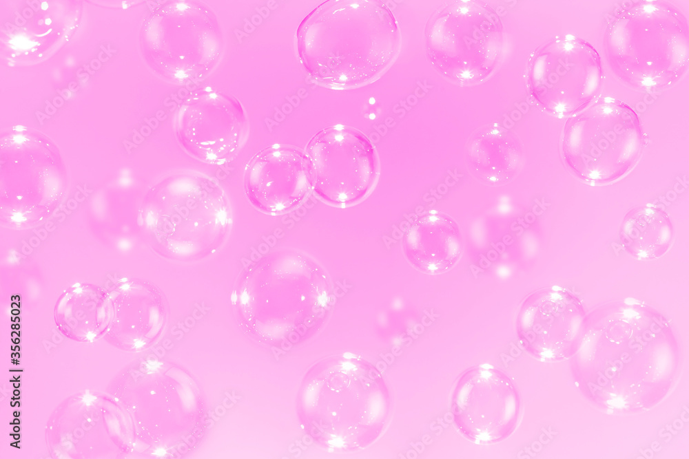Beautiful pink soap bubbles float as background.