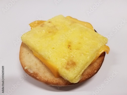 sandwich on desk with bun, egg, and cheese