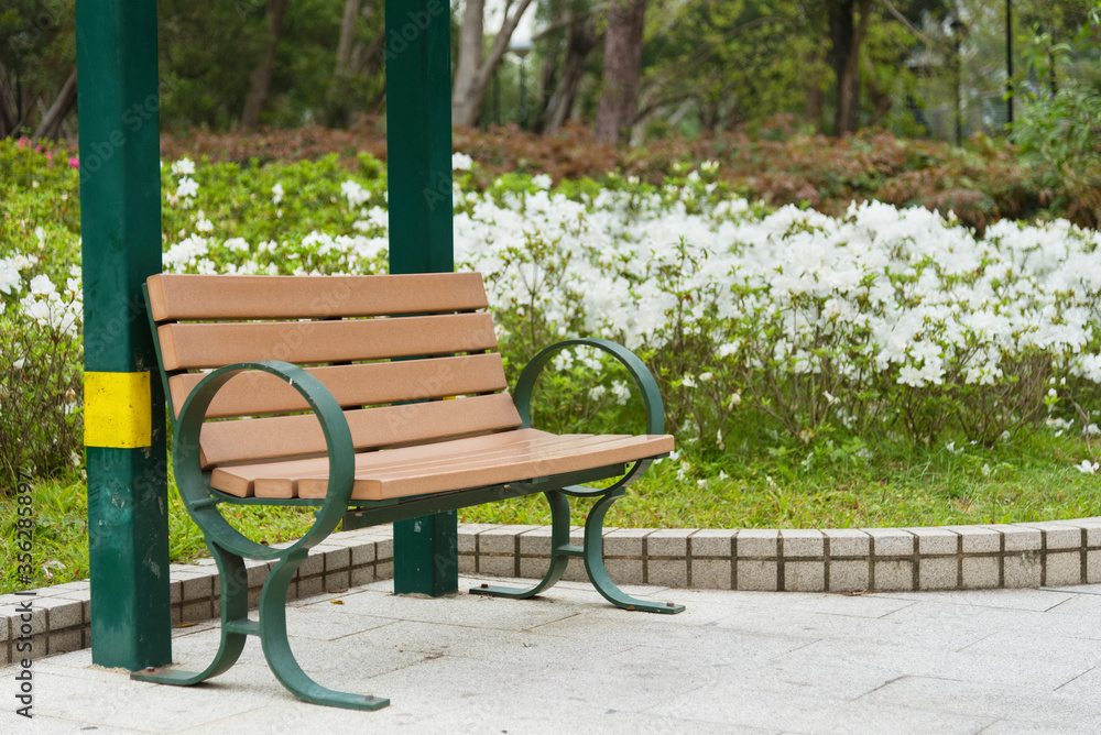 empy bench in green park in springtime season