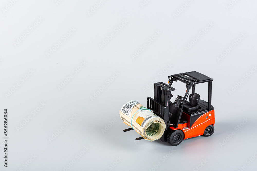 forklift with roll of dollars on gray background. Strongest financial assistance, support of business and people after coronavirus covid-19 pandemic. Mockup with copy space forklift with roll of dollars on gray background. Strongest financial assistance, support of business and people after coronavirus covid-19 pandemic. Mockup with copy space