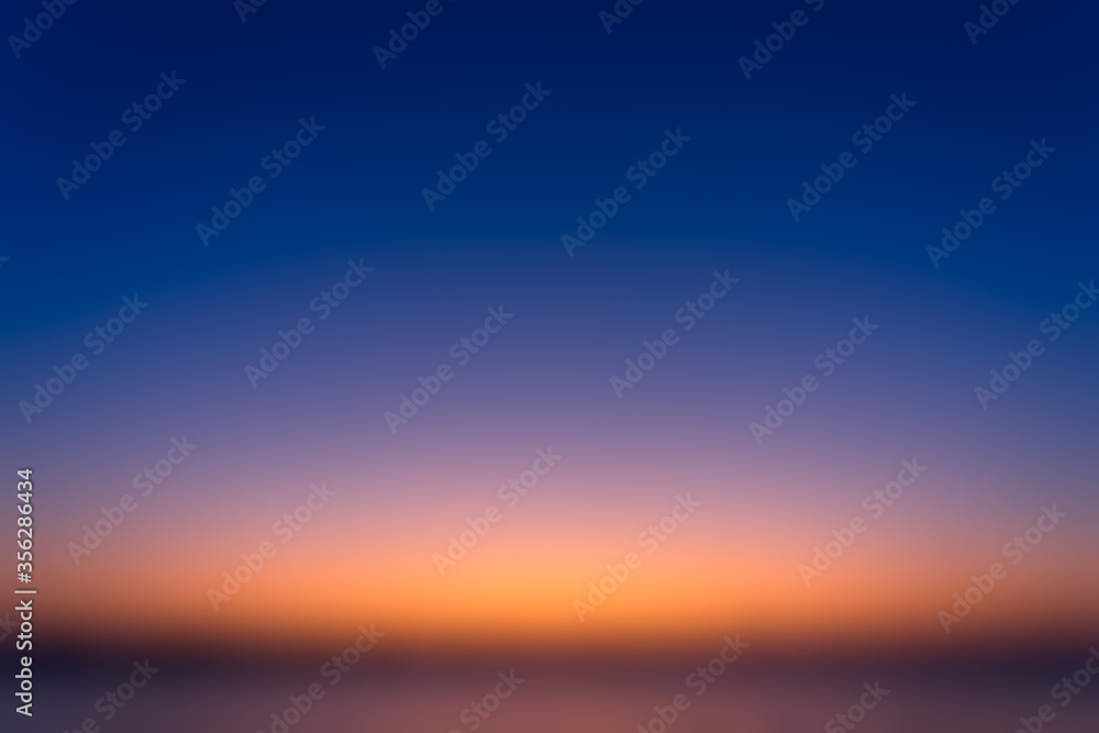 Beautiful blurred sky before sunrise with a natural gradient of orange and blue sky background.
