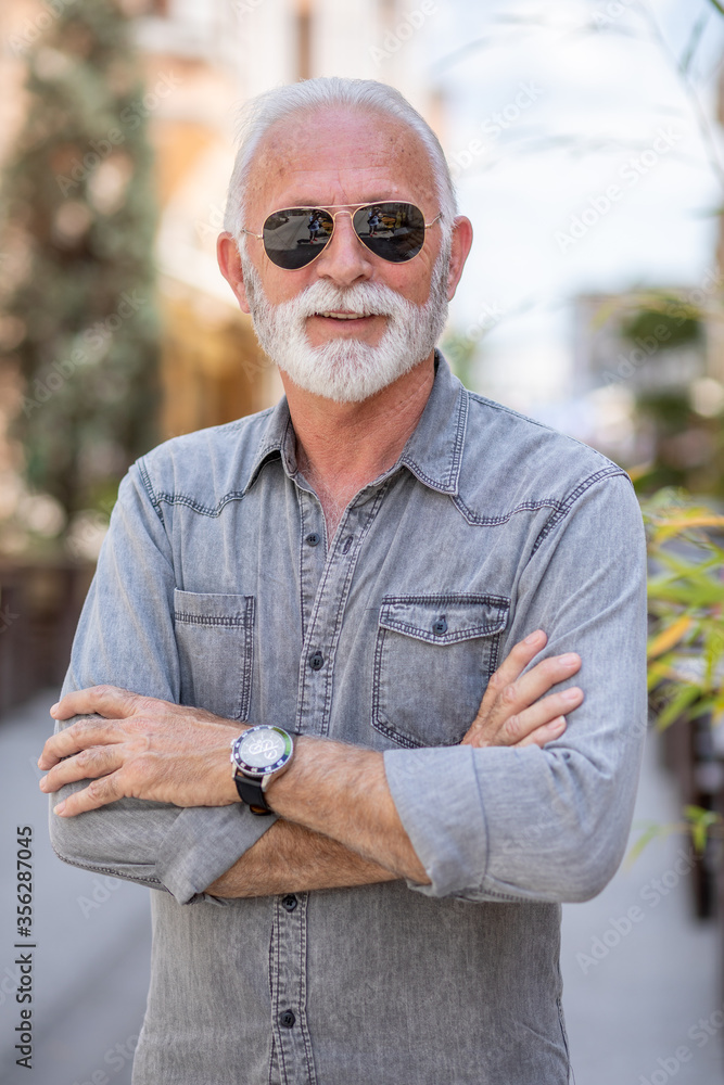 Old rich man with sun glasses and beard on street portrait Old rich man with sun glasses and beard on street portrait