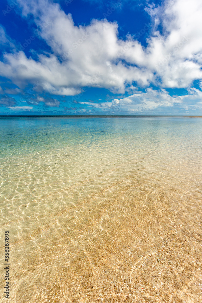Tropical beach with blue sky and water ripples on a sandy beach