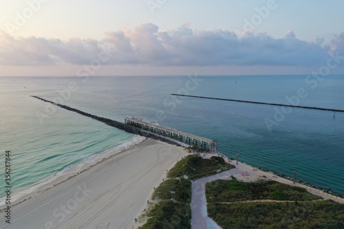 Aerial view of Government Cut and South Pointe Park on Miami Beach, Florida at sunrise in calm weather during COVID-19 shutdown.