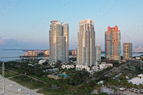 Aerial view of South Pointe Park and South Beach in Miami Beach  Florida at sunrise with Port Miami and City of Miami skyline in background.