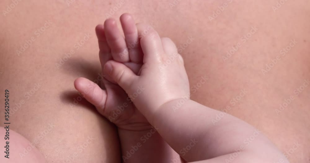Boy's hands resting on mother's chest Boy's hands resting on mother's chest