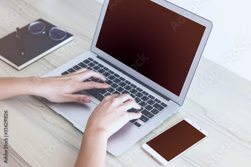 Close up female hands typing on laptop keyboard, woman blogger working online, writing financial report.