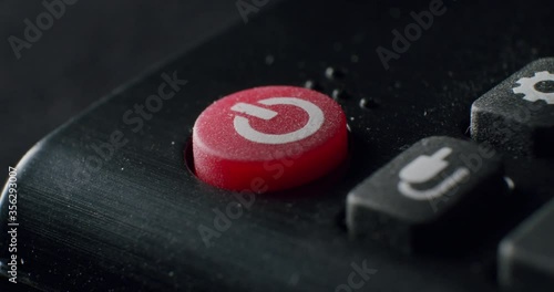 Extreme Closeup of On Off Power Button on Remote Control being pressed