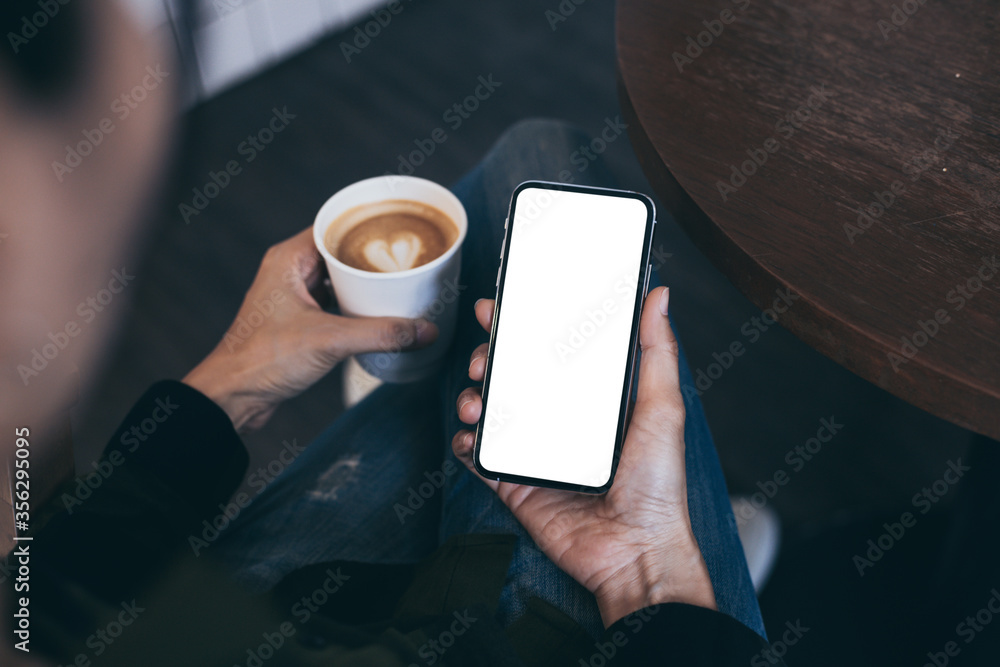 cell phone mockup image blank white screen.woman hand holding texting using mobile on desk at coffee shop.background empty space for advertise.work people contact marketing business,technology cell phone mockup image blank white screen.woman hand holding texting using mobile on desk at coffee shop.background empty space for advertise.work people contact marketing business,technology