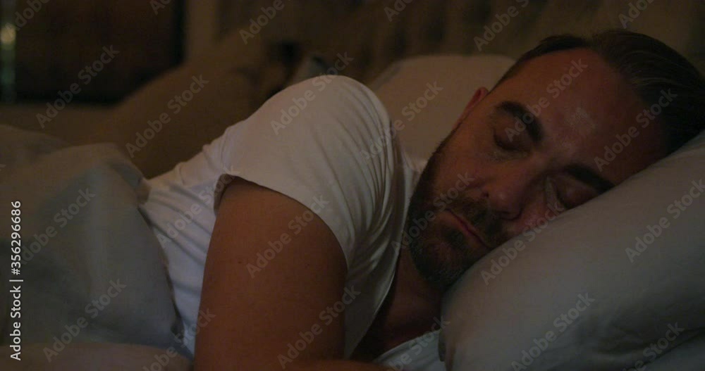 Bearded man peacefully sleeping in his bed. Bearded man peacefully sleeping in his bed.