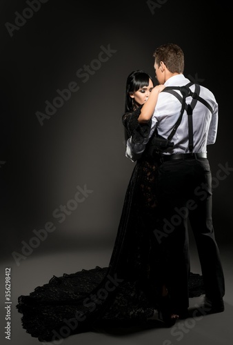 Sexy young couple embracing in the dark shot