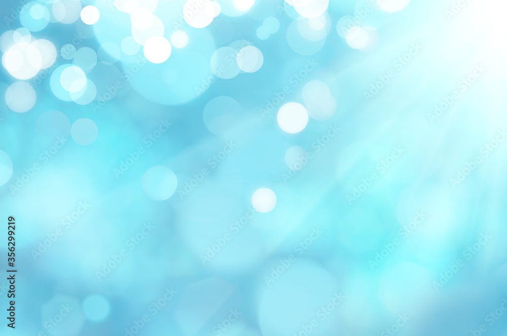 Fototapeta premium Blue and white bokeh background from natural. Bright glowing blue abstract background in the form of bokeh.