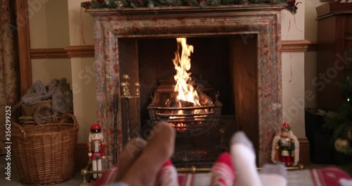 MS TU TD Family with son (6-7) relaxing on sofa near fireplace with Christmas decorations / Dinton, Wiltshire, UK photo