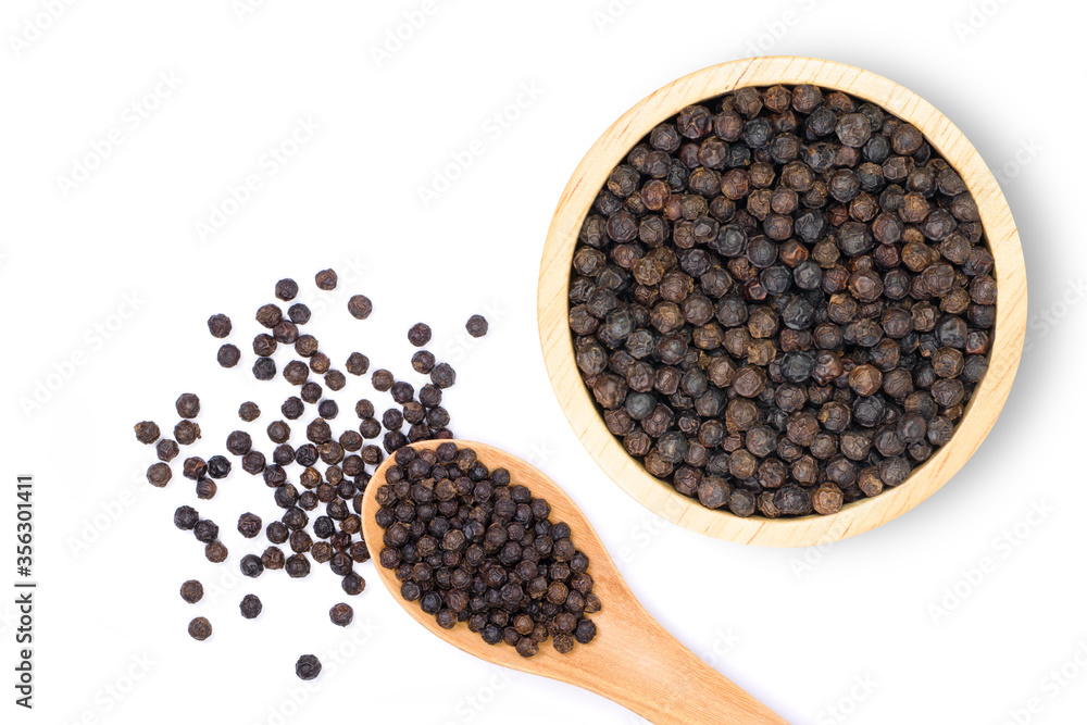 Close up black pepper seeds or peppercorns ( dried seeds of piper nigrum) in wooden bowl and spoon isolated on white background with clipping path. top view. Flat lay. Close up black pepper seeds or peppercorns ( dried seeds of piper nigrum) in wooden bowl and spoon isolated on white background with clipping path. top view. Flat lay.